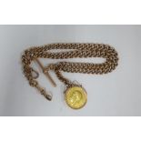 George V 1911 gold full sovereign in a 9ct gold mount on a 9ct gold Albert watch chain