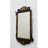 Mahogany fretwork and parcel gilt mirror with eagle and shell carving and a rectangular glass plate.