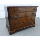 An oak chest, the rectangular top with moulded edge over four graduating long drawers, flanked by