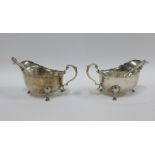 George V pair of silver sauce boats together with accompanying sauce ladles with pierced dividers,