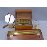 Brass navigation ruler in a fitted mahogany box, reproduction brass compass, astral chart, small