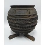 African stoneware pot with geometric pattern, on an x shaped wooden stand, overall height 38cm