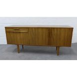 A mid 20th century walnut sideboard credenza in the manner of Morris of Glasgow, with three