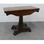 19th century rosewood fold over card table with red baize, with facet column and lappet carving on a