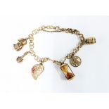 9ct gold bracelet hung with a collection of six 9ct gold charms