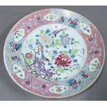 Large famille rose charger with rising rim painted with flowers and precious objects, the well
