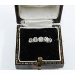 An 18ct gold and platinum diamond five stone dress ring, set with graduating bright cut diamonds,