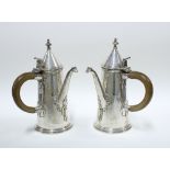 Pair of George V silver café au lait pots, with domed lids and wooden handles, the spouts with