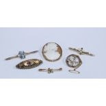 A collection of 9ct gold brooches to include a Cameo brooch, two seed pearl brooches, two aquamarine