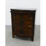 Reproduction bow front chest with a pull out slide over three drawers. 79 x 60 x 46cm.