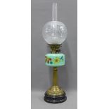 Oil lamp with green glass well and brass column on an ebonised circular base, with etched glass