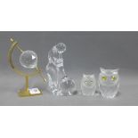 Two Swarovski glass owls, a cut glass globe on gilt meal stand and a glass blower figure (4)