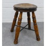 19th century stool with an elm circular top, on three turned legs united by a metal cross stretcher.