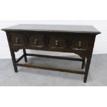 Jacobean style table of dresser base form, with panelled freeze drawers with brass teardrop handles,