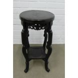 Ebonised chinoiserie two tier jardiniere table, with circular top and stylised pierced frieze, 57