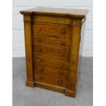 A miniature Victorian walnut Wellington chest, with inverted top over six drawers with wellington