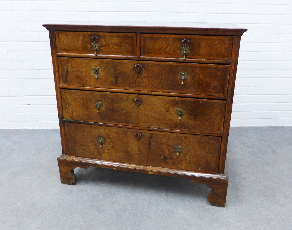 Walnut and feather banded chest with two short and three graduating long drawers, on bracket feet.