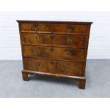 Walnut and feather banded chest with two short and three graduating long drawers, on bracket feet.