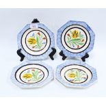 Set of four octagonal creamware plates, with underglaze coloured tulips within spattered blue