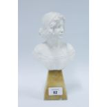 White painted head and shoulders bust, on a a faux hardstone base, 24cm high.