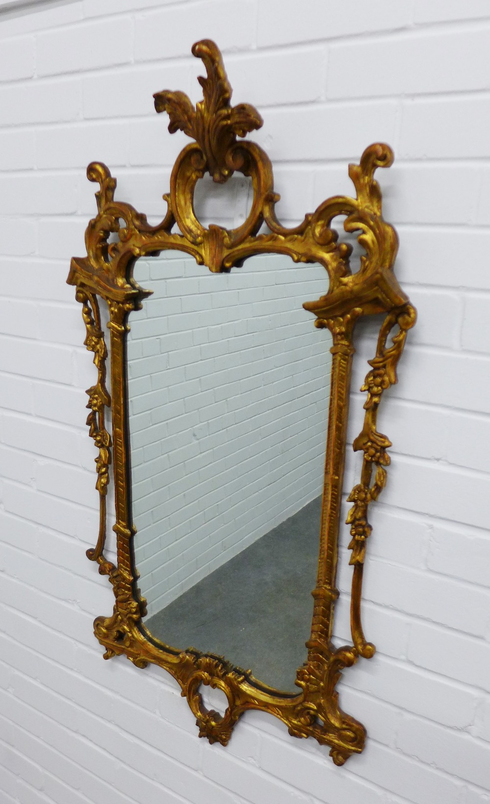 Rococo style gilt framed wall mirror. 109 x 59cm.