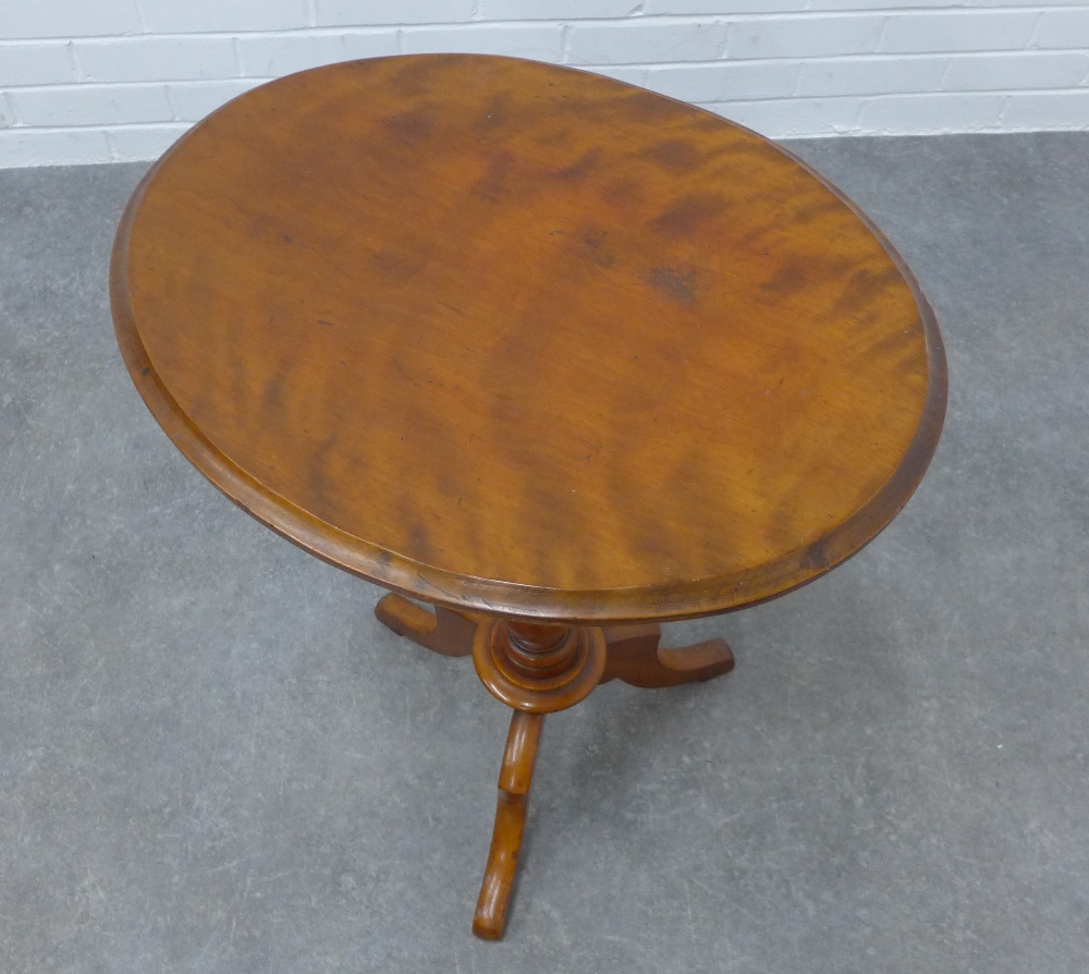 Mahogany pedestal table with an oval top and outswept tripod legs, 72 x 55 x 43cm. - Image 2 of 3