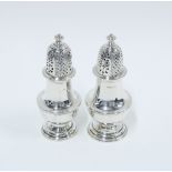 Pair of Victorian silver castors, Chester 1897, of baluster form with pierced covers, 12cm (2)