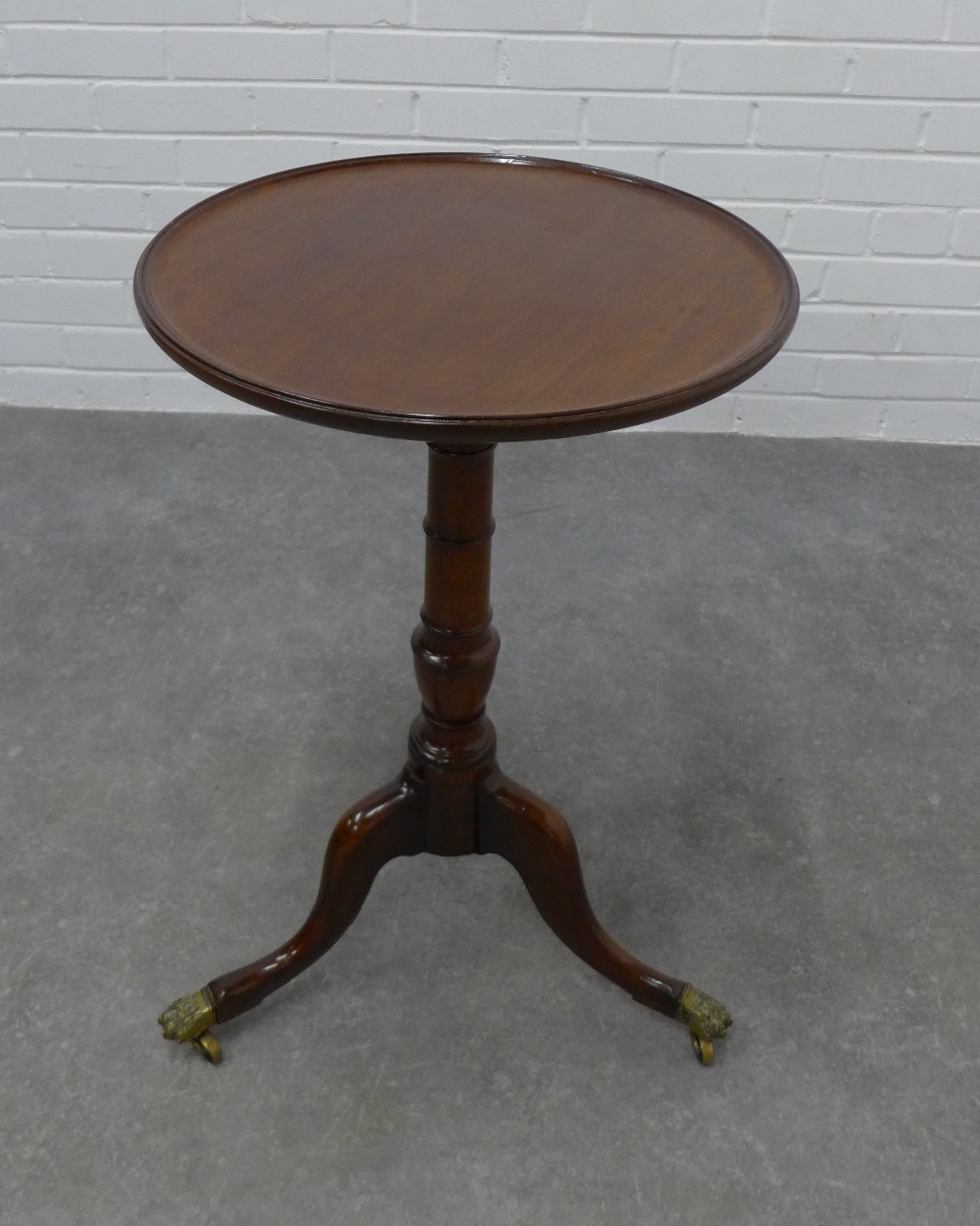 Mahogany pedestal table, the circular dished top on a baluster turned column and tripod legs with