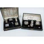 George V silver five piece condiment set, boxed (with one glass liners missing) and a silver three
