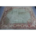 Large pale green carpet with central medallion and flowerhead border, 414 x 324cm (a/f)