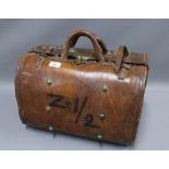 Early 20th century Indian brown leather carry case with interior pockets, brass studs and