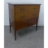 Edwardian mahogany chest, the rectangular top above two long drawers and pair of cupboard doors on