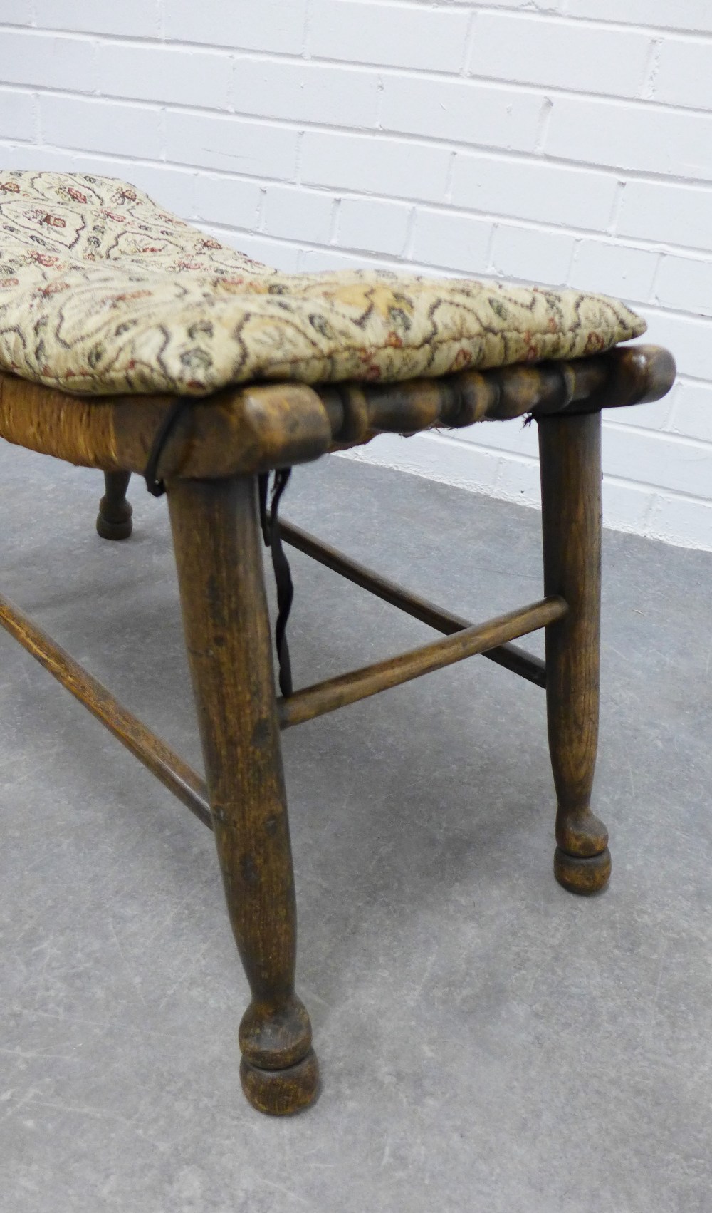 An Arts & Crafts elm stool with a concave woven rush seat, 39 x 76 x 33cm. - Image 2 of 3