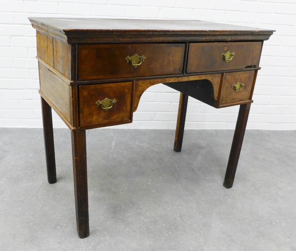 Georgian oak and walnut veneered lowboy, the rectangular top over four frieze drawers with brass