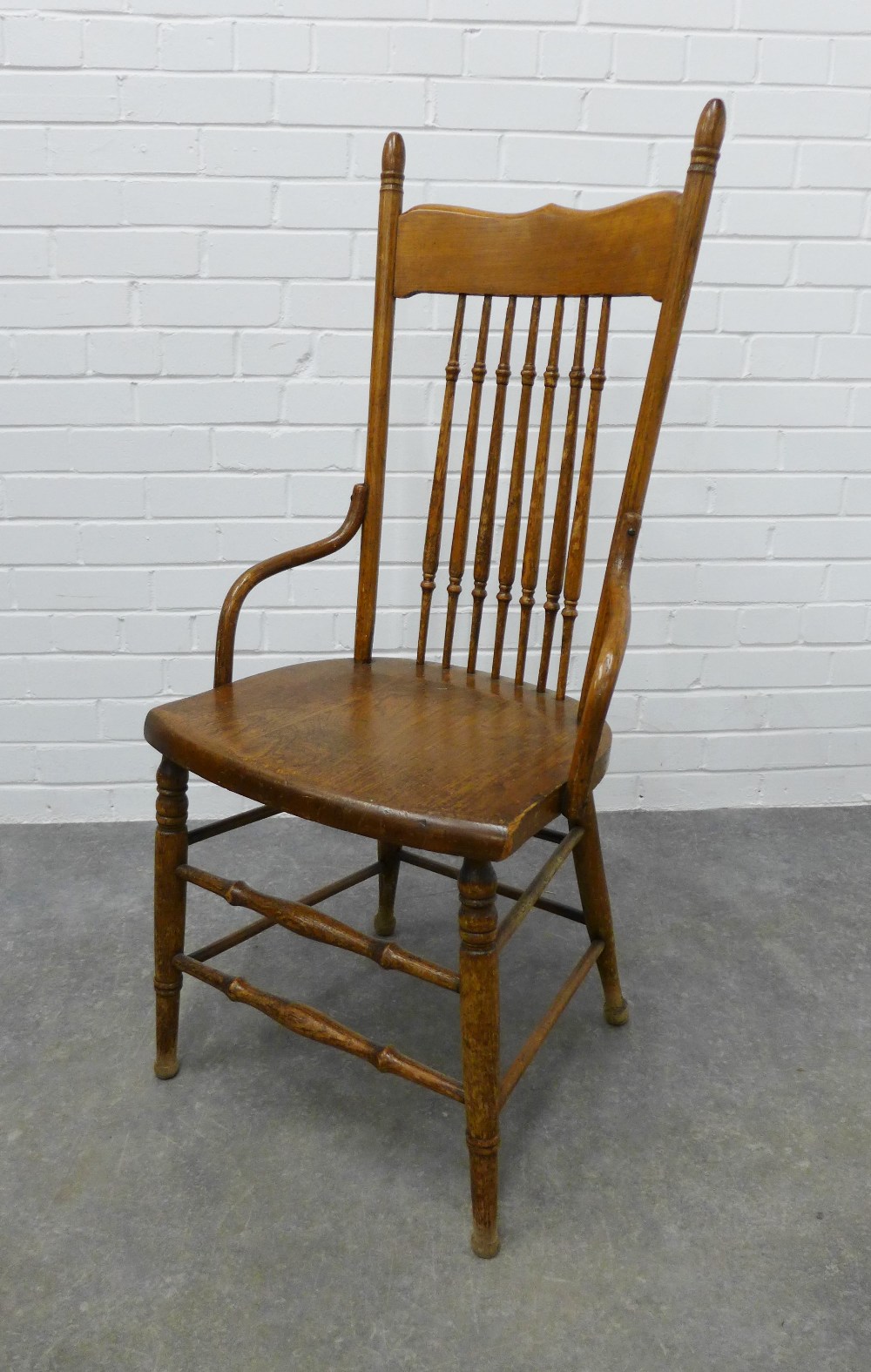 An Arts & Crafts oak spindle back chair in the manner of William Birch, . 109 x 50 x 42cm.