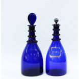 Two Bristol blue glass decanter one with a glass stopper the other with a pewter stopper (2) 29cm.
