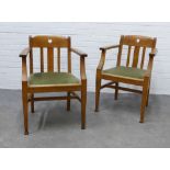 A pair of Arts & Crafts oak open armchairs in the manner of Liberty & Co, with pierced