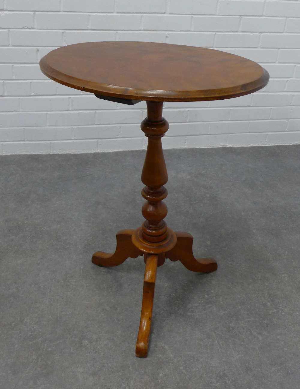 Mahogany pedestal table with an oval top and outswept tripod legs, 72 x 55 x 43cm.