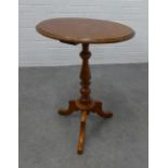 Mahogany pedestal table with an oval top and outswept tripod legs, 72 x 55 x 43cm.