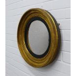 Circular gilt framed wall mirror with an ebonised slip. 47cm.