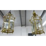 A pair of hexagonal brass and glass panelled lantern light fitting, 34 x 67cm (2)