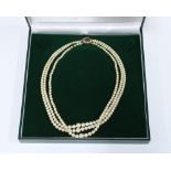 Vintage triple strand cultured pearl necklace with a 9ct gold garnet and seed pearl clasp, stamped