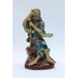 Japanese glazed pottery figure of a seated man with staff, 21cm.