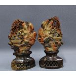 Matched pair of carved soapstone panels with a sage and pot of flowers, on stands, 25cm tall