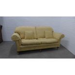 Pale yellow damask upholstered three seater sofa with squab and scatter cushions, on mahogany legs