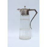 Early 20th century glass claret jug with silver plated mounts 28cm.