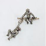 Late 19th / early 20th century double monkey trapeze brooch, each monkey pave set with paste stones,