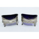 A pair of George III silver navette salts, with blue glass liners, London 1799 (2)