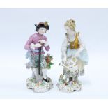 A pair of Sitzendorf porcelain male and female gardening figures, (2) 17cm.