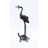 Bronze stork stood upon a turtle, 30cm.